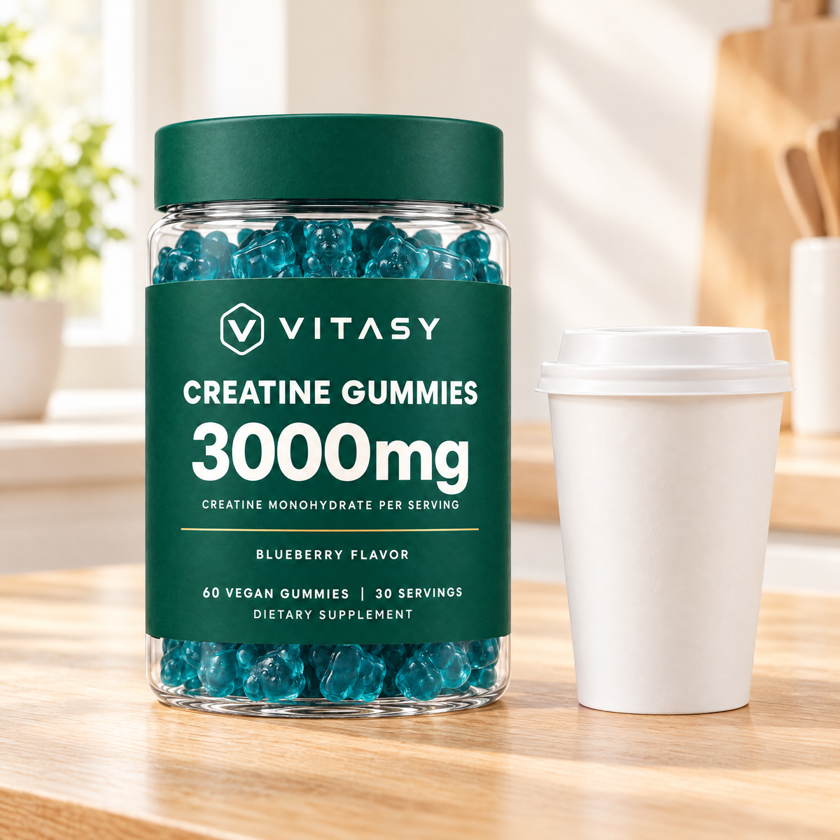 Vitasy Creatine Gummies jar next to a coffee cup on a kitchen counter