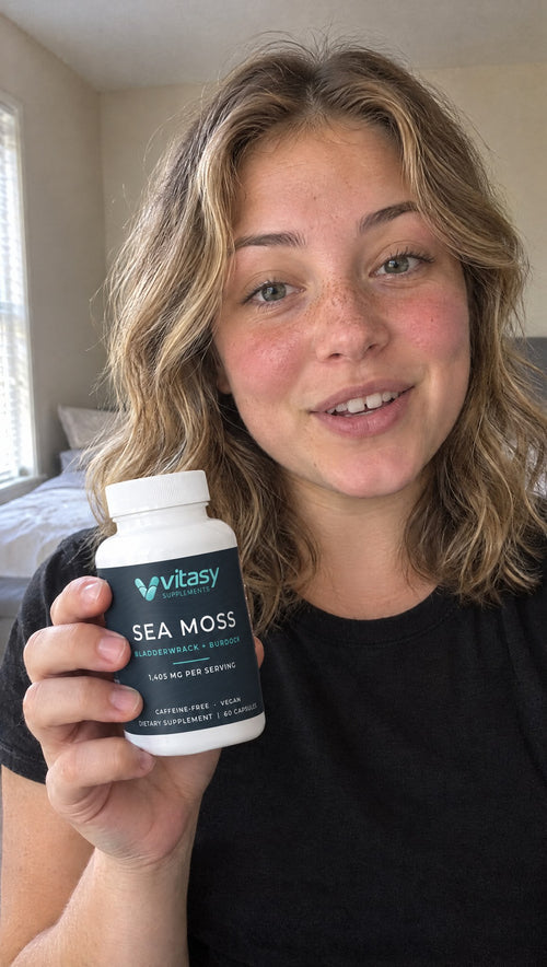 Holding a bottle of Sea Moss Capsules