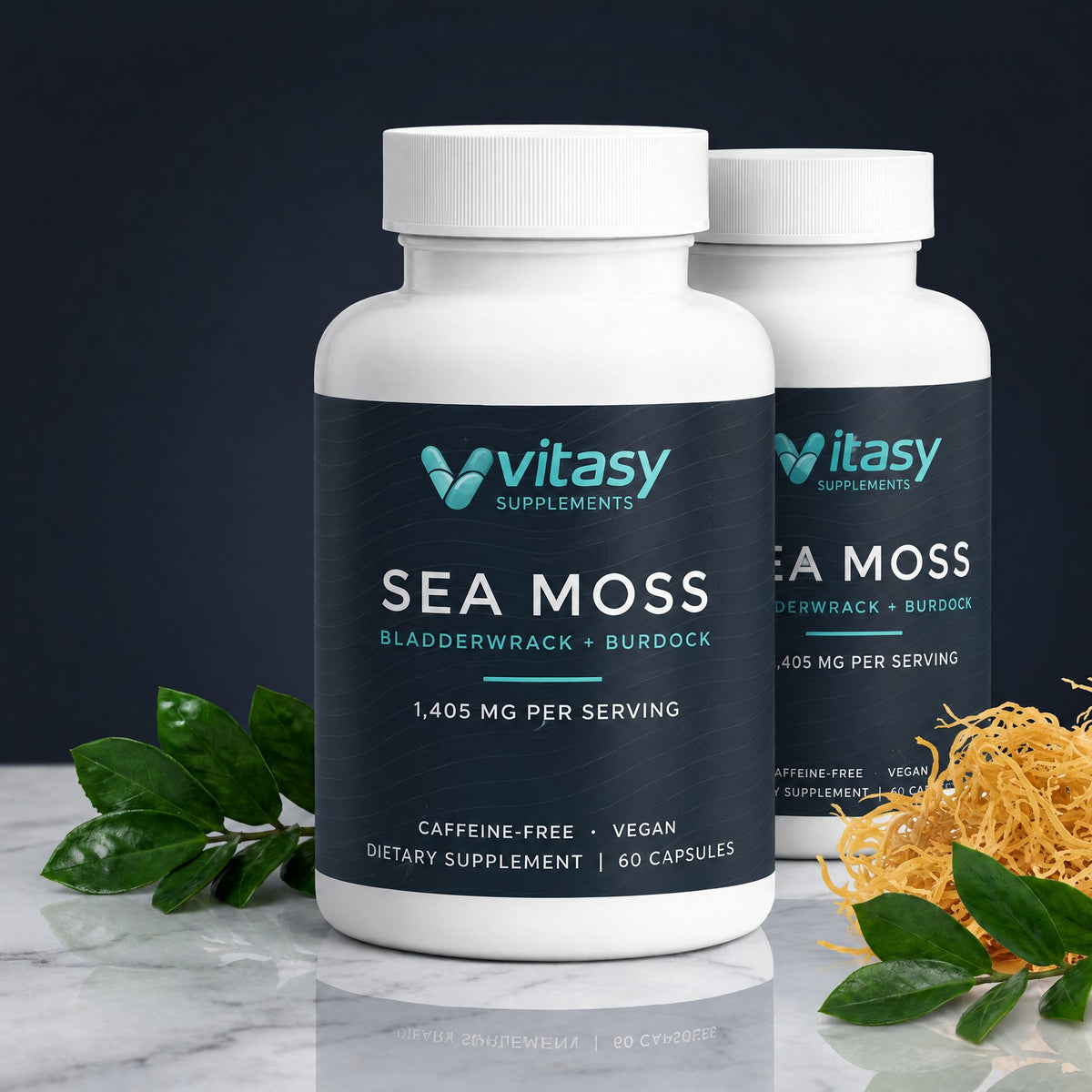 Two bottles of Vitasy Sea Moss Capsules on a marble counter with sea moss and green leaves
